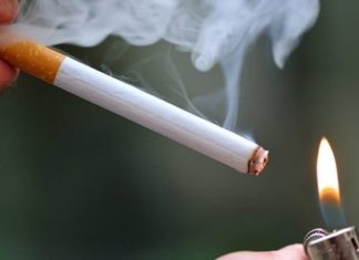 Smoking in colleges Cigarette and burning lighter with smoke